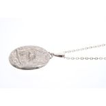 Victorian silver oval locket with embossed design depicting a heron amongst foliage,