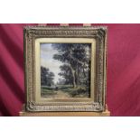 19th century Continental School oil on panel - figure on a wooded path, initialled, in gilt frame,