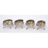 Set of four Georgian silver salts of oval form, with rococo floral and scroll decoration,