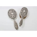 Late 19th / early 20th century Chinese silver hand mirror with raised dragon decoration against a
