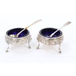 Pair George III silver salts of cauldron form, with embossed floral decoration, on three hoof feet,