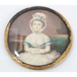 Late 18th century Continental portrait miniature on ivory depicting a young woman, seated on a sofa,