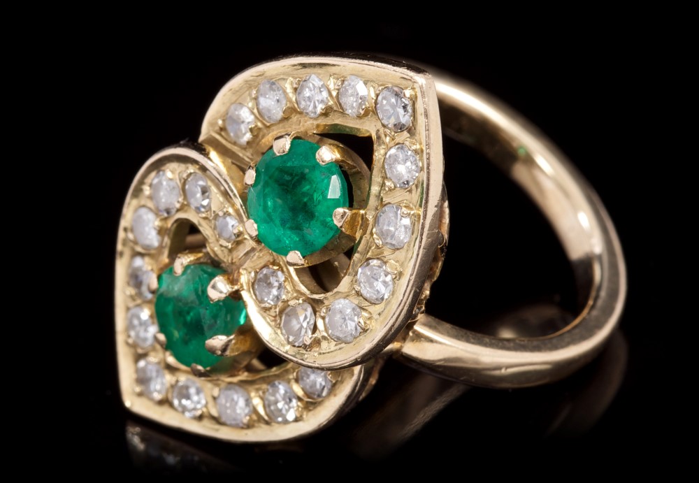 Emerald and diamond cocktail ring in the form of two interlocking hearts,