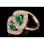 Emerald and diamond cocktail ring in the form of two interlocking hearts,