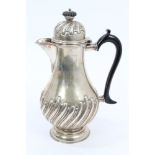 Victorian silver coffee pot of baluster form, with raised wrythen decoration, black scroll handle,