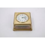 Unusual late 19th century table clock with square brass case, horizontal white enamel dial,