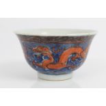 Antique Chinese tea bowl decorated in red and blue enamels with Imperial five-clawed dragons