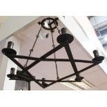 Antique wrought iron six-light chandelier of hexagonal form, suspended from chains,