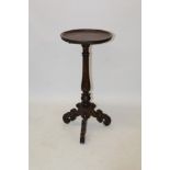 17th century-style oak candle stand with dished top on turned column and tripod scrolled supports,