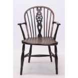 Early 19th century yew and elm Windsor chair with pierced wheel splat back and solid saddle seat on