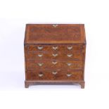George II walnut crossbanded and featherbanded bureau - the sloping fall enclosing fitted interior