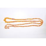 Old amber necklace with a string of graduated faceted amber beads, 129cm long.
