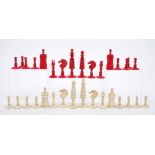 19th century carved ivory and red stained ivory chess set, queen 8cm high,
