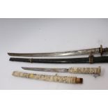 Late 19th century Japanese ornamental sword with carved bone figure decoration to hilt and scabbard