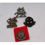 Four scarce Second World War British plastic badges - East Surrey, Middlesex,