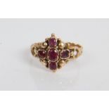 Victorian five stone garnet cluster ring with scroll work shoulders and engraved yellow metal shank.