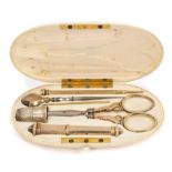 Late 19th / early 20th century French sewing kit with silver gilt sewing instruments in an oval