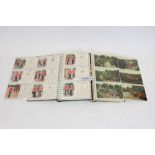 Postcards in two albums - military collection - including real photographic Escort 1st Life Guards