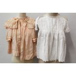 Selection of baby clothes in wicker basket and box - including cream silk dresses, silk shawl,