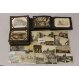 Postcards in two albums - including real photographic cards, G.B.