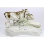 Early 20th century Austrian pottery figure of two cows at a watering trough, signed - C.