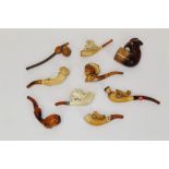 Collection of carved meerschaum cheroot holders - to include two carved with horses,