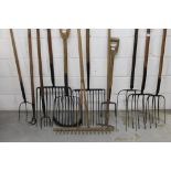 Collection of antique farm forks - including multi-pronged examples, pitchforks, wooden rake,