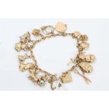 Gold (9ct) charm bracelet with various gold and yellow metal novelty charms CONDITION