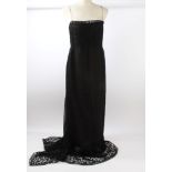 Chanel evening gown in black silk crepe, with Chanel logo and lettering,