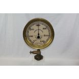 Large early 20th century brass pressure gauge with circular white dial,
