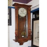 Early 20th century Vienna-style regulator wall clock striking on a gong with brass pendulum bob,