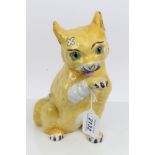 Mosanic yellow glazed pottery model of a cat licking its paw CONDITION REPORT