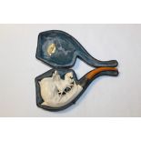 Large 19th century meerschaum pipe carved with three horses, silver collar and amber mouthpiece,