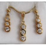 Gold (18ct) diamond three stone pendant drop on gold (9ct) chain and a matching pair of diamond