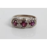 White gold (18ct) ruby and diamond triple cluster ring.