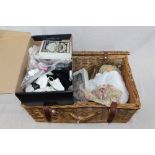 Dolls' clothes and accessories in wicker basket - including hats, shoes, lace and ribbon cape,