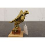 Gilt metal eagle mascot mounted on wooden plinth,