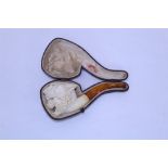 Finely carved Continental meerschaum pipe, the bowl carved as a snarling lion, amber mouthpiece,