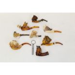 Eight late 19th century meerschaum pipes and cheroot holders carved with eagle and skull, 15cm,