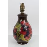 Moorcroft Pottery lamp decorated in the Hibiscus pattern on brown ground - impressed mark to base,