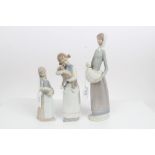 Two Lladro porcelain figures - girl holding lamb and girl holding piglet,