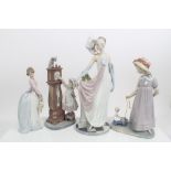 Four Lladro porcelain figures - lady in 1920s outfit, girl pulling doll in a cart,