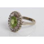 White gold (18ct) peridot and diamond cluster ring.