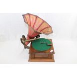 Table-top gramophone with a large and impressive red tin horn and winding handle