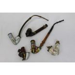 Five good 19th century Continental porcelain pipes - including one in the form of a headless