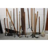 Diverse antique farming implements - including pitchfork, metal axes,