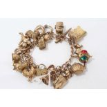 Gold (9ct) charm bracelet with quantity of gold and yellow metal novelty charms CONDITION