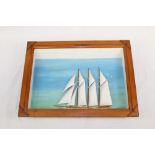 Ships' diorama depicting three-masted racing yacht, in glazed case,