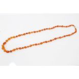 Antique amber necklace with a string of graduated faceted amber beads, 89cm.