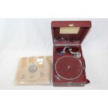 Early 20th century portable wind-up gramophone in a maroon case,